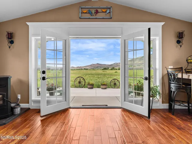 a view of a porch with furniture and a yard