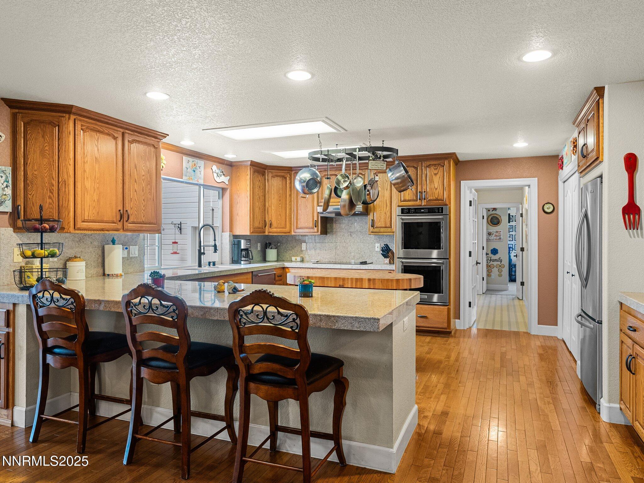 801 Larson Lane Coleville, CA 96107 - Photo 9 of 37 a kitchen with stainless steel appliances granite countertop table chairs sink and cabinets