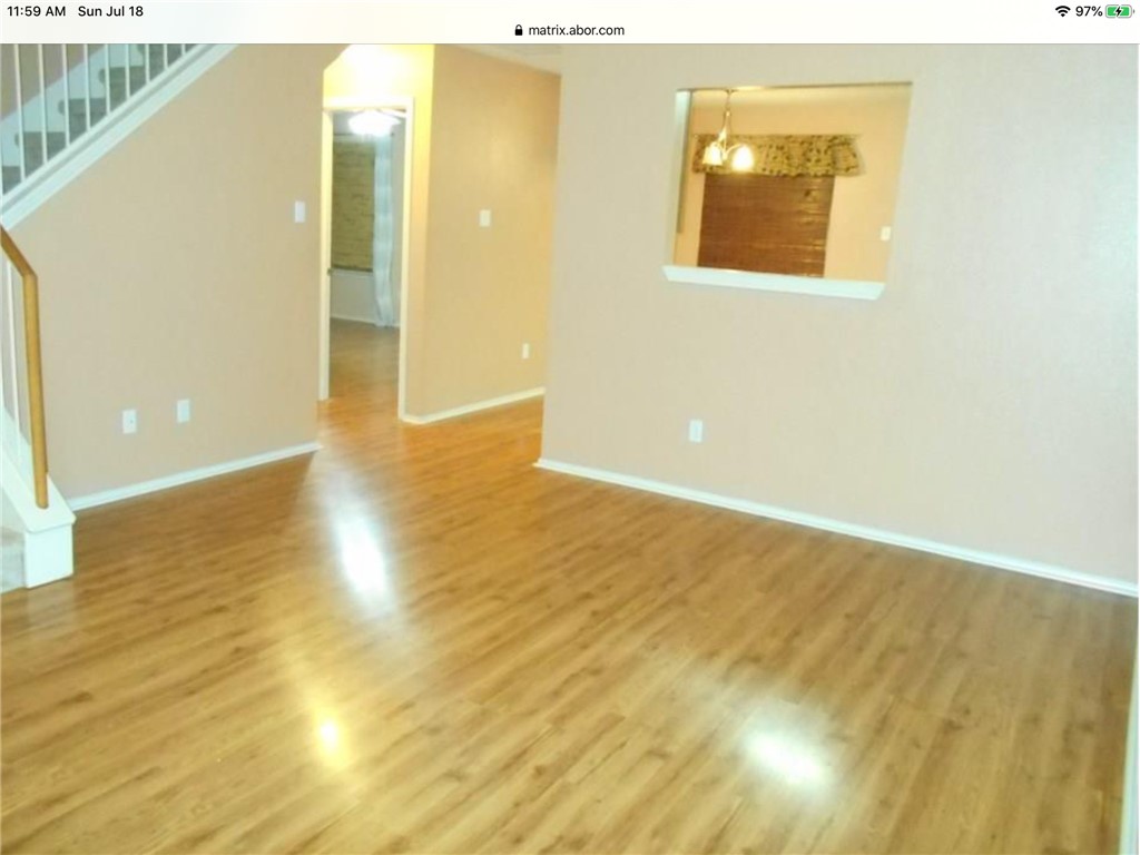a view of an empty room and wooden floor