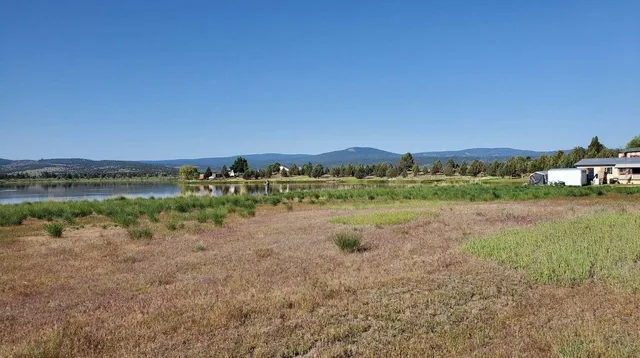 a view of a lake with houses in the back
