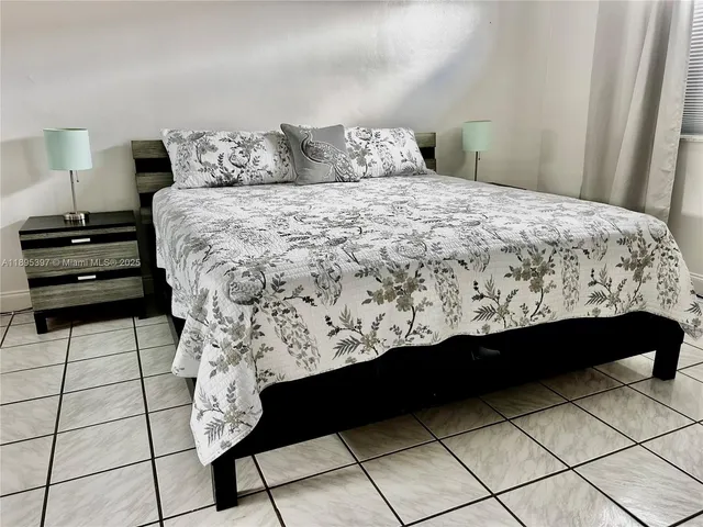 a bed sitting in a bedroom next to a window