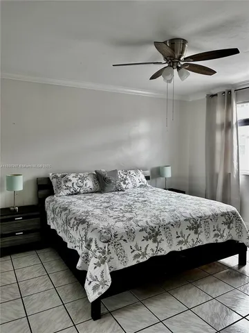 a bedroom with a bed and ceiling fan
