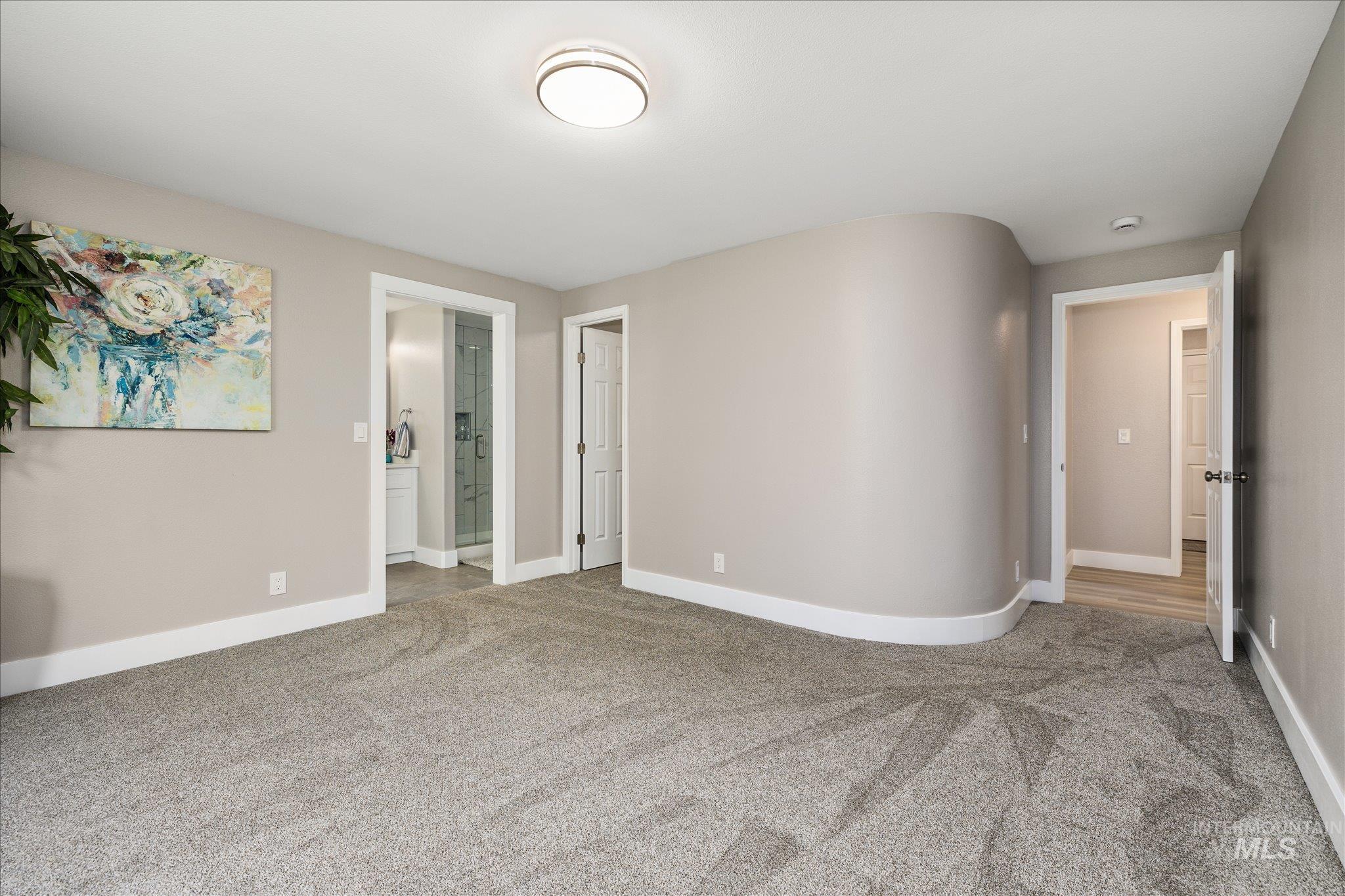2250 North Amethyst Avenue Meridian, ID 83646 - Photo 30 of 50 Unfurnished bedroom with light carpet and ensuite bath