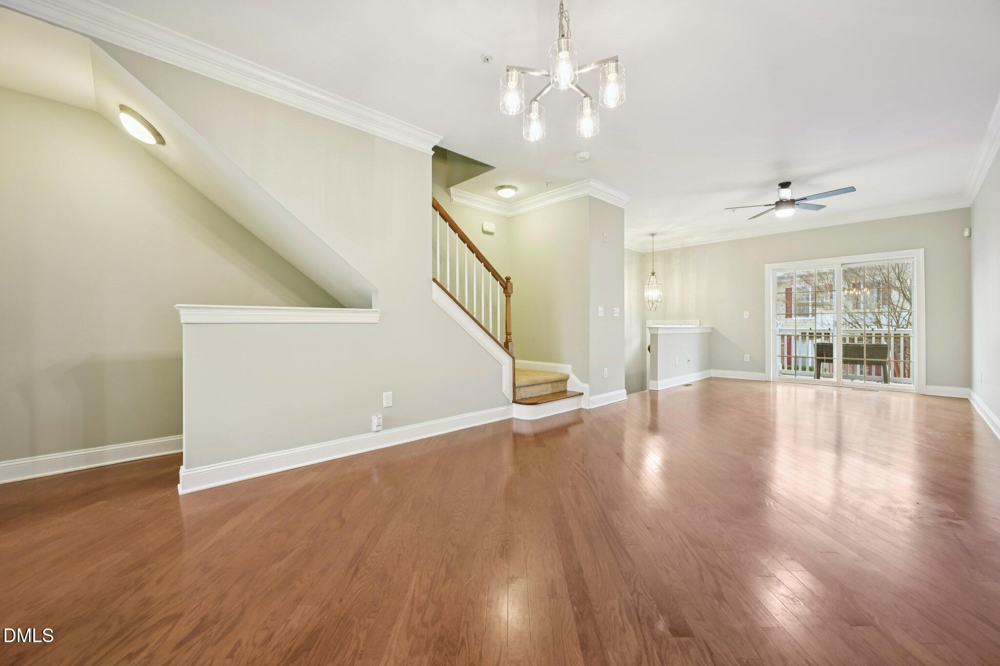 10510 Sablewood Drive, Unit 113 Raleigh, NC 27617 - Photo 11 of 38 a view of an empty room with wooden floor and a window