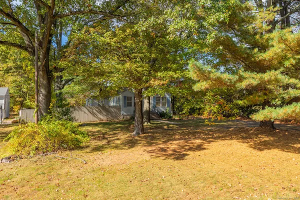 a view of a yard with yellow house