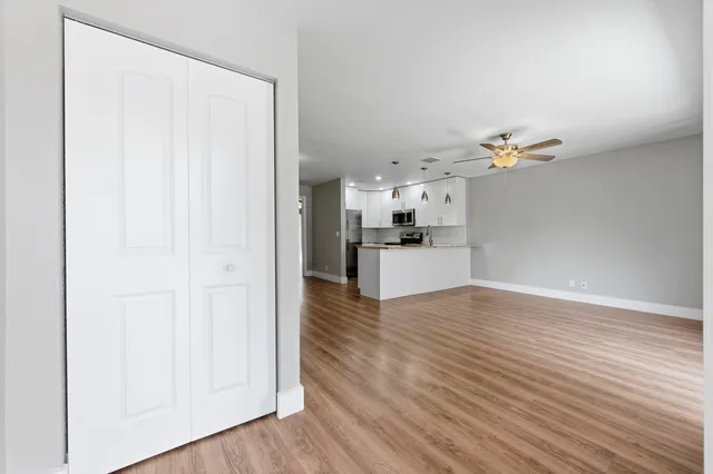 a view of a kitchen with wooden floor