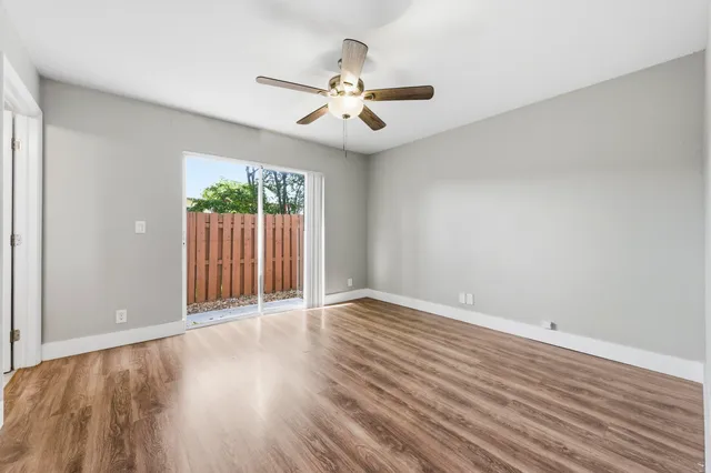 wooden floor in an empty room with a window