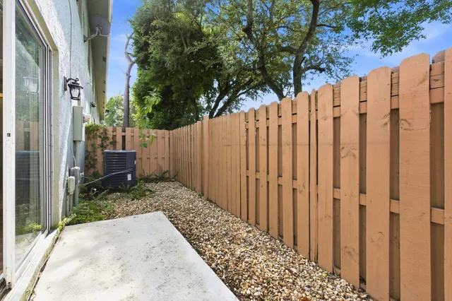 a view of a pathway gate with wooden fence