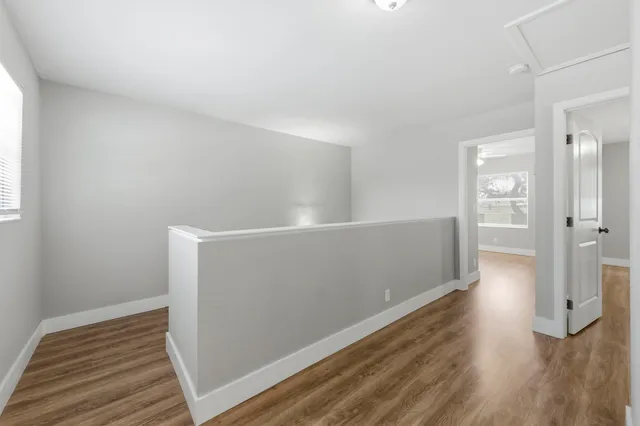 a view of a room with wooden floor