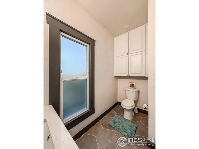 a bathroom with a toilet and a shower curtain