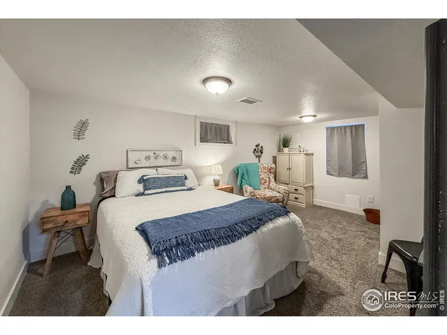 a bedroom with a bed a table and chair