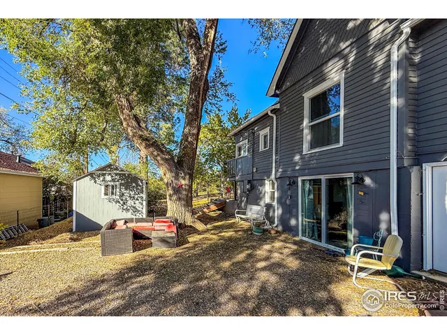 a backyard of a house with table and chairs