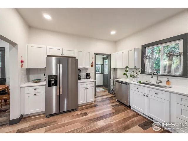 a kitchen with a refrigerator and a sink