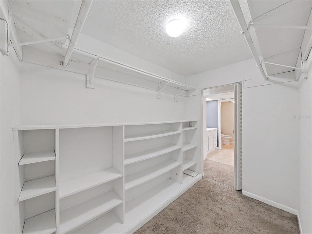 700 Starkey Road, Unit 624 Largo, FL 33771 - Photo 14 of 24 a view of walk in closet with empty racks