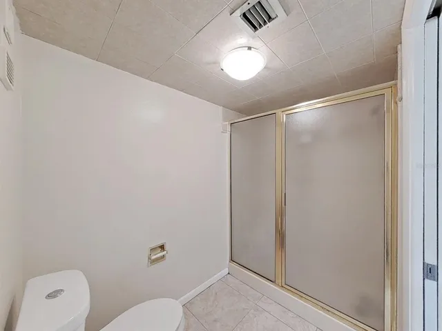 a bathroom with a shower a toilet and a sink