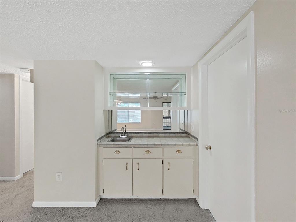 700 Starkey Road, Unit 624 Largo, FL 33771 - Photo 7 of 24 a bathroom with a granite countertop sink and a mirror