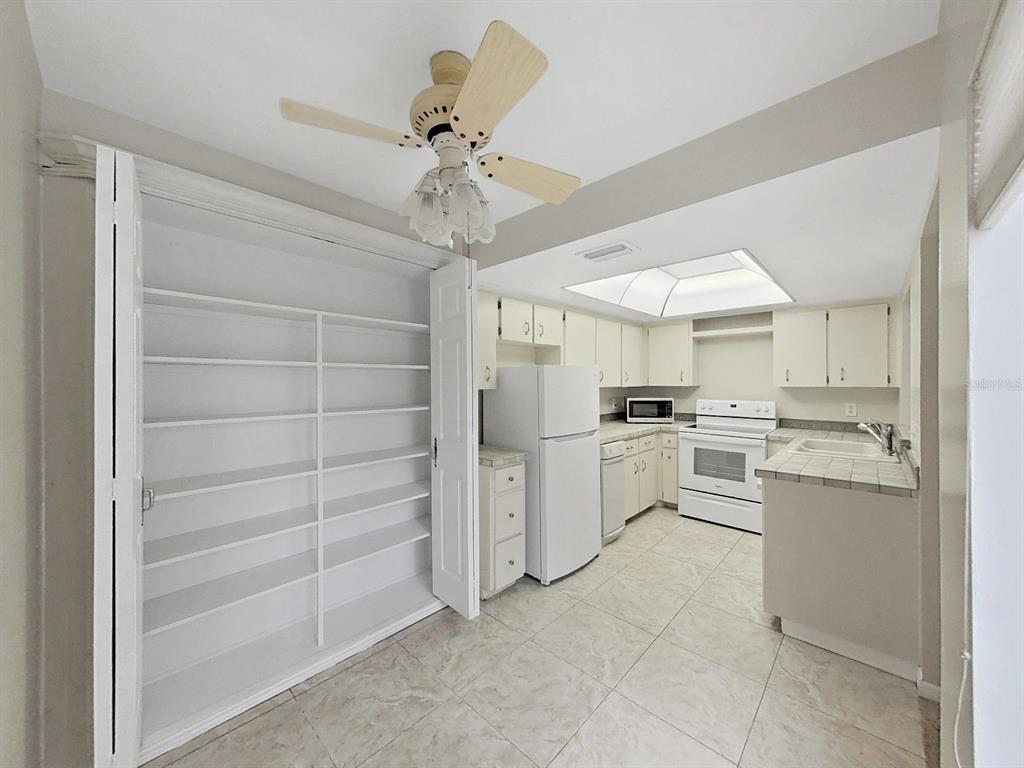 700 Starkey Road, Unit 624 Largo, FL 33771 - Photo 8 of 24 a kitchen with white cabinets and white appliances