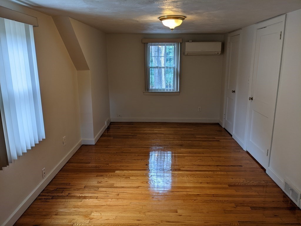 620 Alden Street Springfield, MA 01109 - Photo 5 of 11 a view of an empty room with wooden floor and a window