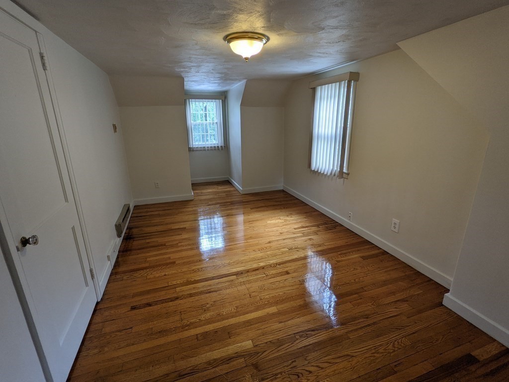 620 Alden Street Springfield, MA 01109 - Photo 6 of 11 a room with lots of frames on wall and wooden floor
