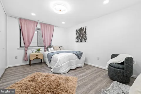 a bedroom with a bed and a couch