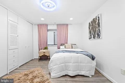 a bathroom with a toilet a sink a mirror and vanity