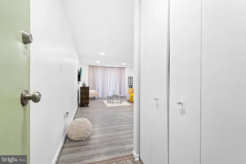 a view of a hallway with wooden floor and staircase