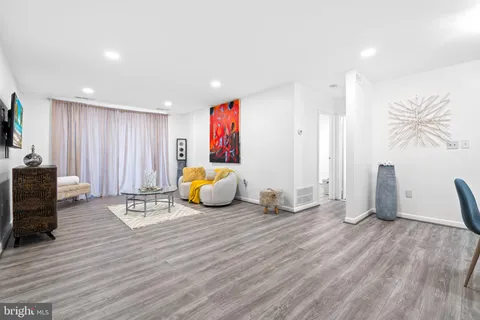 a view of a room with wooden floor and furniture