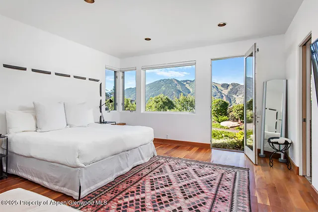 a bedroom with a bed and a potted plant