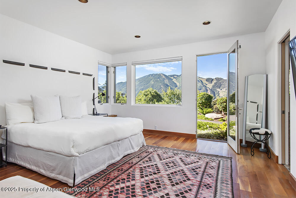804 Hunter Creek Road Aspen, CO 81611 - Photo 23 of 31 a bedroom with a bed and a potted plant