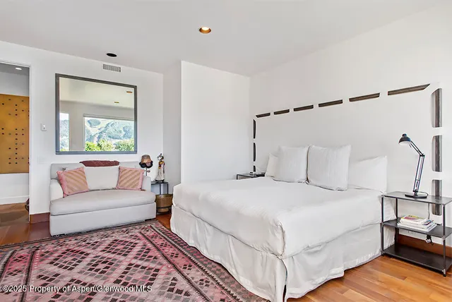 a bedroom with a bed and a couch