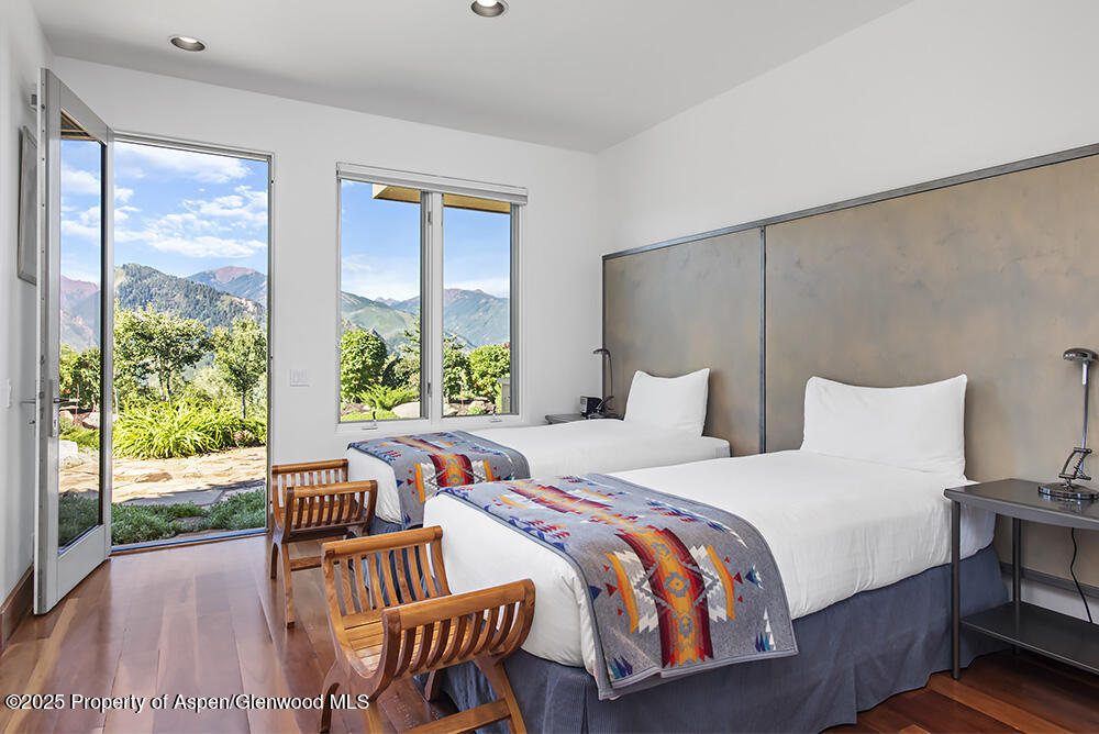 804 Hunter Creek Road Aspen, CO 81611 - Photo 26 of 31 a bedroom with a bed and wooden floor