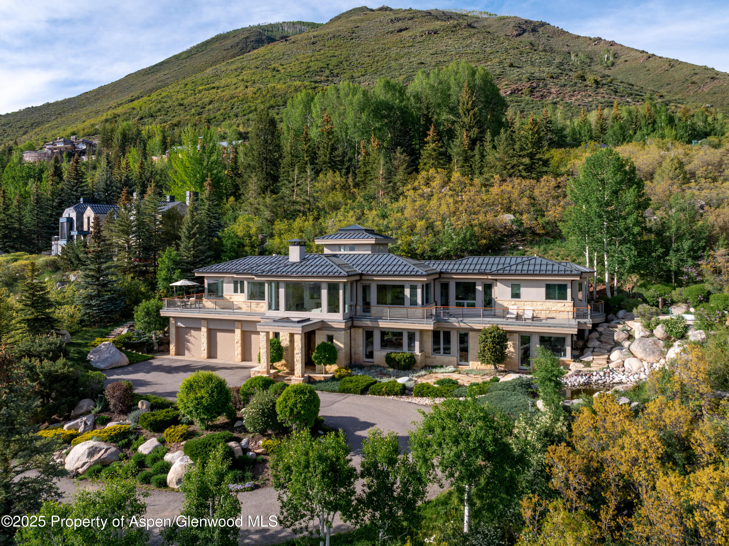 804 Hunter Creek Road Aspen, CO 81611 - Photo 28 of 31 a front view of a house with a yard and potted plants