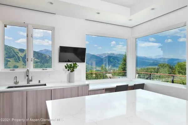 a large white kitchen with a large window