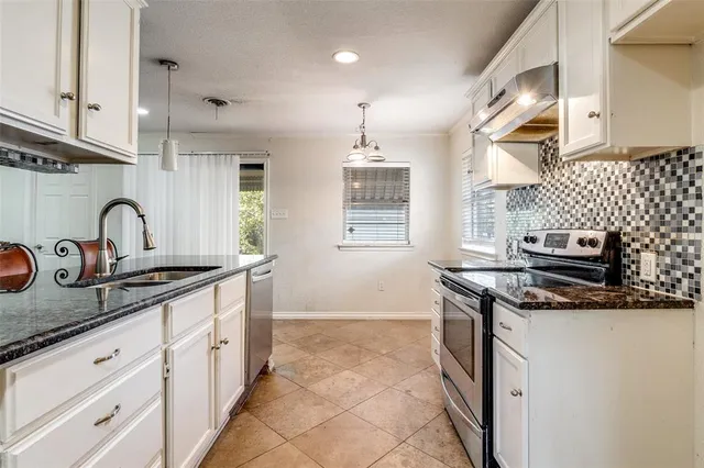 a kitchen with stainless steel appliances granite countertop a stove and a sink