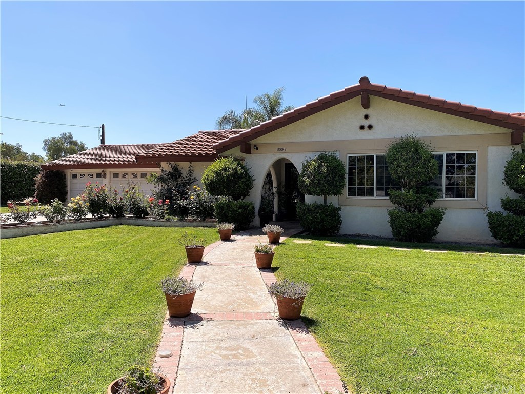 18885 Bert Road Riverside, CA 92508 - Photo 1 of 1 a view of a house with backyard sitting area and garden