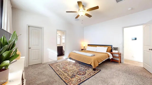 a bathroom with a granite countertop bathtub sink vanity mirror and toilet