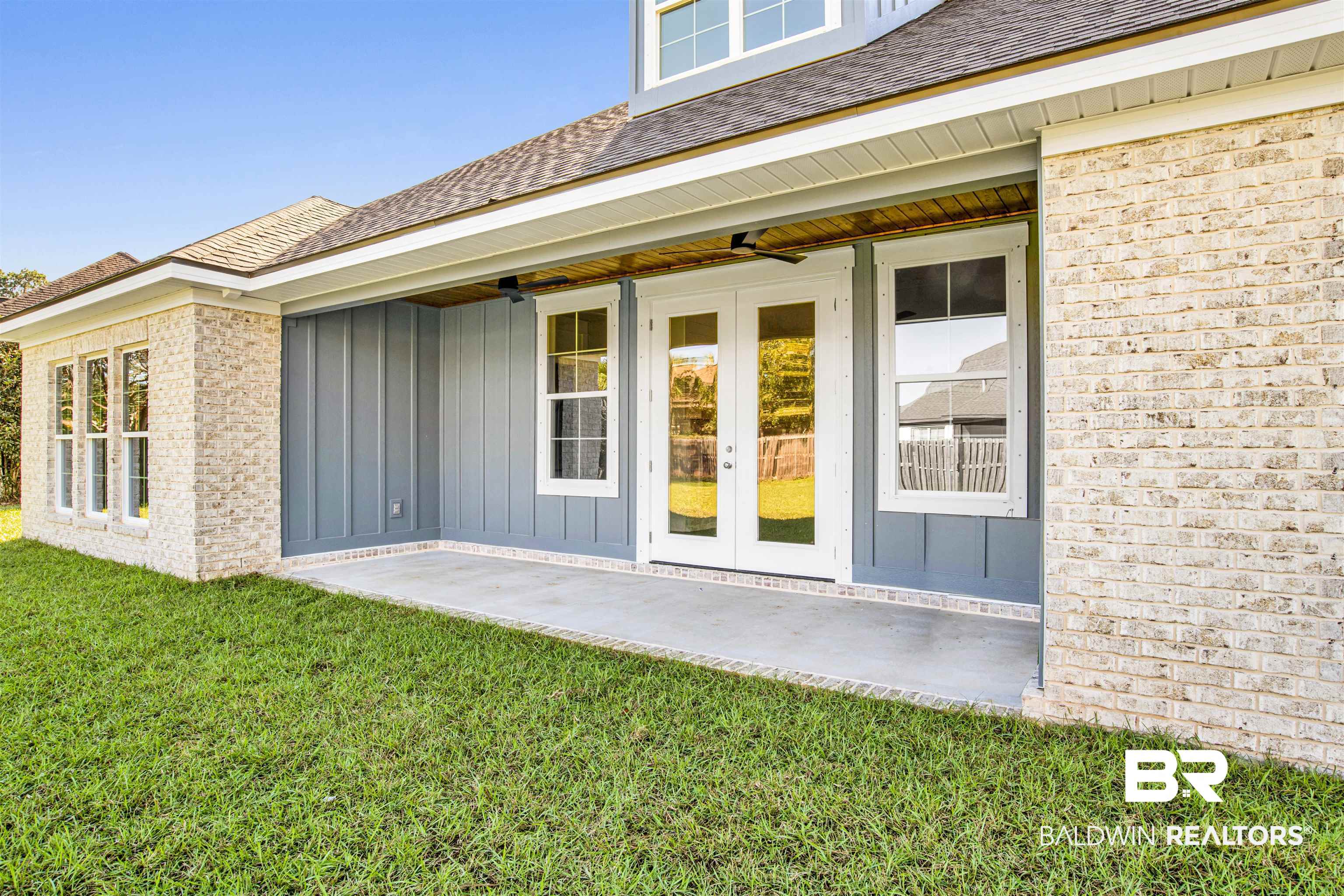 9687 Widgeon Court Daphne, AL 36526 - Photo 33 of 40 Back patio with french doors, a patio, ceiling fan, and a lawn