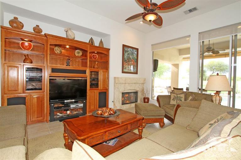 178 Loch Lomond Road Rancho Mirage, CA 92270 - Photo 11 of 32 a living room with furniture a flat screen tv and a fireplace