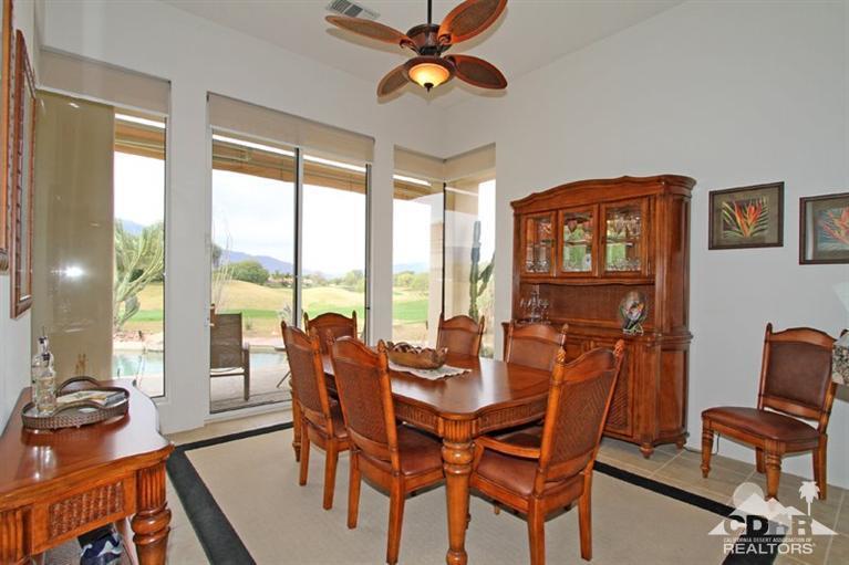 178 Loch Lomond Road Rancho Mirage, CA 92270 - Photo 15 of 32 a dining room with furniture a chandelier and a large window
