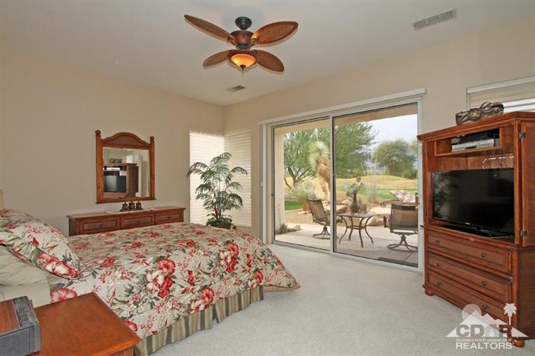 178 Loch Lomond Road Rancho Mirage, CA 92270 - Photo 16 of 32 a bedroom with a bed and a flat tv screen on dresser