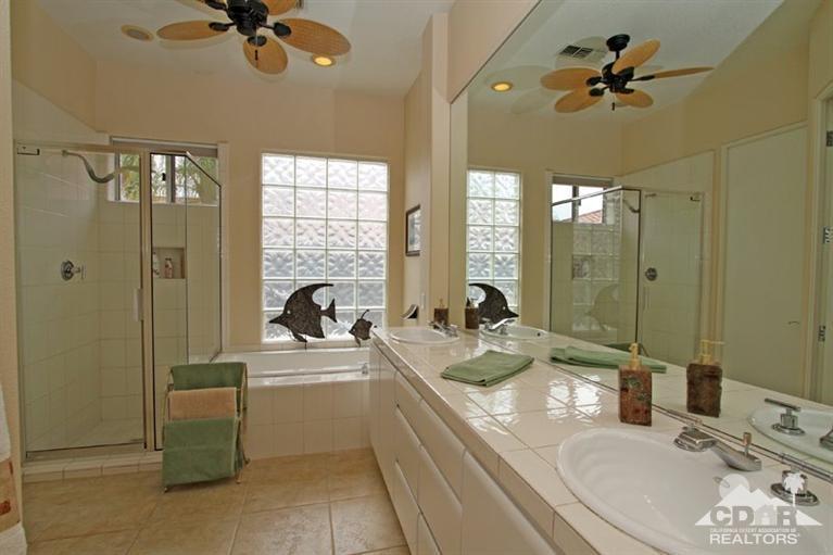 178 Loch Lomond Road Rancho Mirage, CA 92270 - Photo 17 of 32 a en suite bathroom with a granite countertop tub sink a mirror and shower