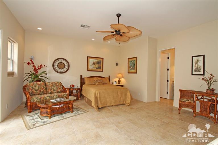 178 Loch Lomond Road Rancho Mirage, CA 92270 - Photo 18 of 32 a living room with a couch and dresser