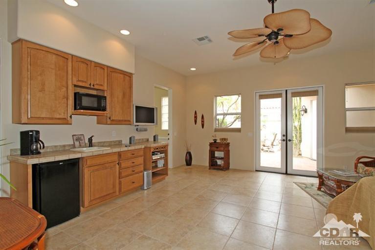 178 Loch Lomond Road Rancho Mirage, CA 92270 - Photo 19 of 32 a view of a kitchen with a sink and a refrigerator