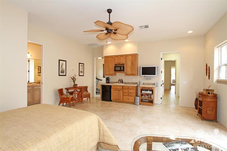 178 Loch Lomond Road Rancho Mirage, CA 92270 - Photo 20 of 32 a bedroom with furniture a flat screen tv and a dresser