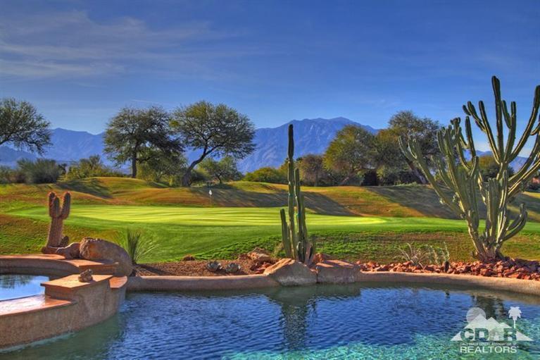 178 Loch Lomond Road Rancho Mirage, CA 92270 - Photo 3 of 32 a view of a garden with an ocean and house in the background