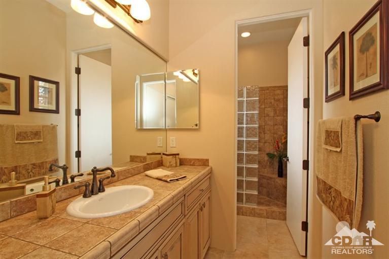 178 Loch Lomond Road Rancho Mirage, CA 92270 - Photo 21 of 32 a bathroom with a granite countertop sink and a mirror