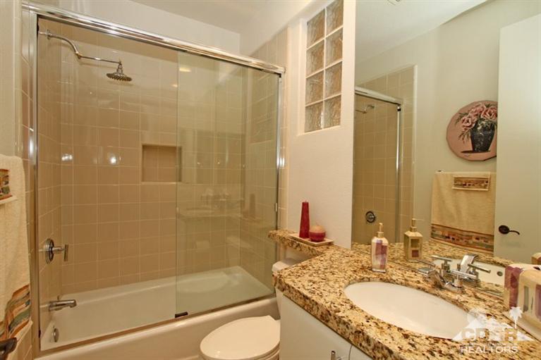 178 Loch Lomond Road Rancho Mirage, CA 92270 - Photo 23 of 32 a bathroom with a granite countertop sink toilet and shower