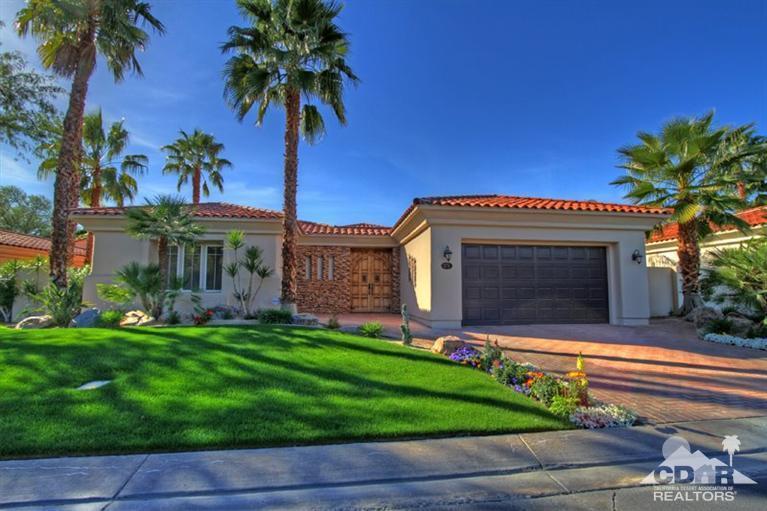 178 Loch Lomond Road Rancho Mirage, CA 92270 - Photo 6 of 32 a front view of a house with a garden and palm tree