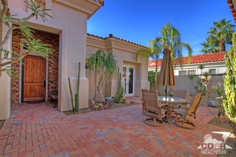 178 Loch Lomond Road Rancho Mirage, CA 92270 - Photo 7 of 32 a view of a chairs and table in a backyard