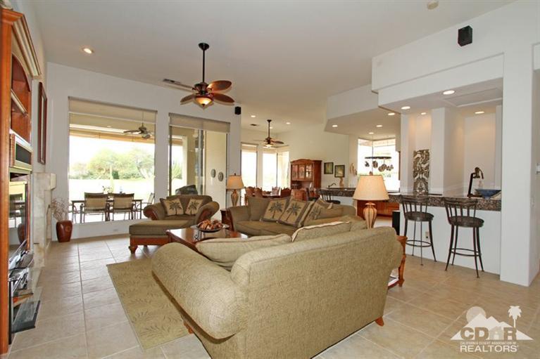 178 Loch Lomond Road Rancho Mirage, CA 92270 - Photo 10 of 32 a living room with furniture a large window and a chandelier